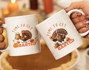 Può includere: Due tazze da caffè bianche con un design di tacchino del Ringraziamento. Le tazze dicono "Time to Get Basted".