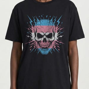 May include: Black t-shirt featuring a skull design with pink, blue, and white accents. The skull has a cracked appearance and is surrounded by lightning bolt graphics. The design is centered on the front of the shirt.