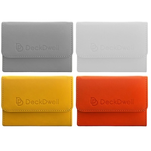 May include: Four card cases in gray, white, yellow, and orange. Each case has a textured surface and a flap closure. The "DeckDwell" logo is embossed on the front of each case.