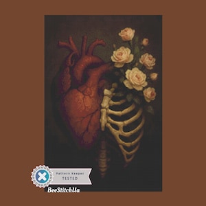 May include: A cross-stitch design featuring a detailed anatomical heart next to a rib cage filled with roses. The heart is a deep red, the roses are pale pink, and the rib cage is beige. The design has a dark, moody aesthetic.