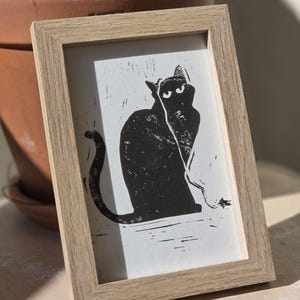 Gatto nero in linoleum - gatto giocattolo blasé