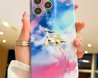 May include: A smartphone case with a vibrant sky-themed design in shades of pink, blue, and white. The case features a graphic of a white and gold creature with Japanese text. The case has a glossy finish and is designed to fit a smartphone.