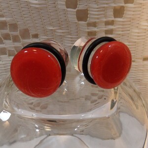 Glass plugs, 1/2 inch red and clear glass plugs, 1/2 gauge