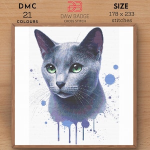 May include: Cross stitch pattern of a blue Russian Blue cat with green eyes, surrounded by blue watercolour splatters. The pattern uses 21 colours and measures 178 x 233 stitches.