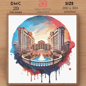 Op de afbeelding: Een kruissteekpatroon van een aquarel van een groot gebouw met een fontein ervoor. Het gebouw is een hotel met een grote koepel op het dak. De fontein is omgeven door bomen en struiken. Het patroon is rond met een druppelend verf-effect rond de randen. Het patroon is voor 290 x 300 steken en gebruikt 29 kleuren.
