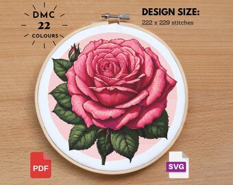 May include: A cross-stitch pattern of a pink rose with green leaves, set in a wooden embroidery hoop. The design includes the text "DMC 22 COLOURS" and "DESIGN SIZE: 222 x 229 stitches". Includes PDF and SVG file icons.