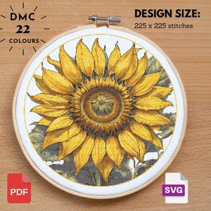 May include: A cross-stitch design of a sunflower in a wooden hoop. The image shows a detailed yellow sunflower with green leaves. The text indicates 22 colours and a design size of 225 x 225 stitches. Includes PDF and SVG file icons.