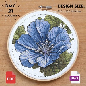 May include: Cross-stitch embroidery of a blue flower with green leaves, set in a wooden hoop. The design size is 215 x 215 stitches. The text reads "DMC 21 COLOURS". Includes PDF and SVG file icons.
