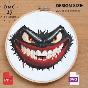 Puede incluir: Un patrón de punto de cruz de un monstruo negro y rojo con una amplia sonrisa de dientes. El patrón está diseñado para 200 x 141 puntos y utiliza 27 colores.