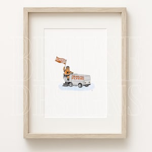 May include: A framed art print featuring a cartoon mascot driving a white ice resurfacer labeled Philadelphia Flyers. The mascot holds an orange flag with the text FLYERED UP. The illustration is centered within a light wood frame.