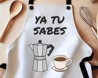 May include: White kitchen apron with black straps and a black and white illustration of a coffee pot and a cup of coffee. The text "Ya Tu Sabes" is printed in black on the apron.