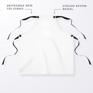May include: White apron with adjustable neck tie straps and a stylish button detail.