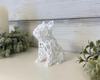 May include: White, 3D printed, wireframe sculpture of a French Bulldog. The sculpture is sitting on a white surface.