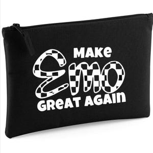 May include: Black zippered pouch with the text "MAKE EMO GREAT AGAIN" in white. The word "Emo" has a checkered pattern. The pouch is rectangular and has a zipper closure.