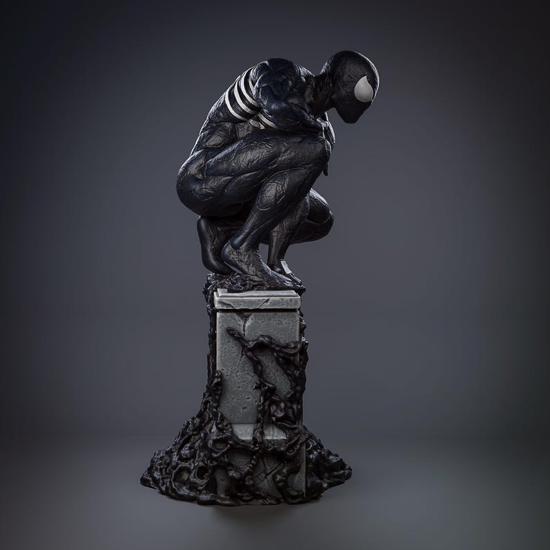 May include: A black and white statue of a crouching superhero figure. The figure is posed on a stone pedestal with a dark, textured base. The superhero has a white spider symbol on the chest and a white spider eye.