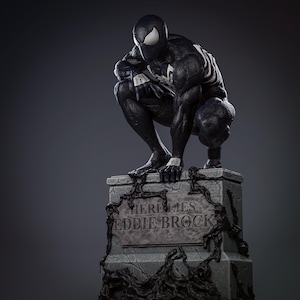 May include: A black and white statue of a superhero in a crouching position atop a stone monument. The monument reads "HERE LIES EDDIE BROCK" in white lettering. The statue has white accents and a spider-like design.