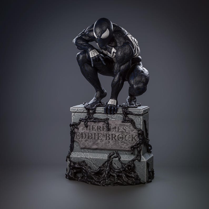 May include: A black and white statue of Venom crouching on a tombstone. The tombstone reads "Here Lies Eddie Brock" and is decorated with dark, organic tendrils. The statue has white accents and a menacing expression.