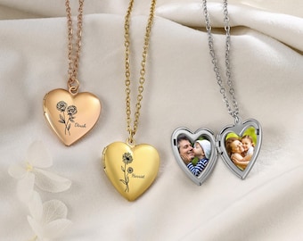 May include: Three heart-shaped lockets on chains. One is rose gold with a rose design and the name "Dinah". Another is gold with a daisy design and the name "Harriet". The third is silver and open, revealing two photos.