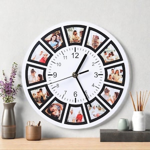 May include: White round wall clock with black hands and numbers. The clock face features a series of photo frames around the perimeter, each holding a different family photo. The clock is on a wooden surface.