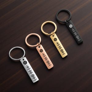 May include: Four keychains with a rectangular pendant and a circular keyring. The pendants are in silver, rose gold, gold, and black. Each keychain features a music-themed icon and a barcode-like design, likely a scannable code.