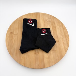 May include: A set of three ceramic mugs with a speckled, matte finish. The mugs are in shades of cream, light gray, and dark gray. Each mug has a simple, minimalist design, perfect for coffee or tea.