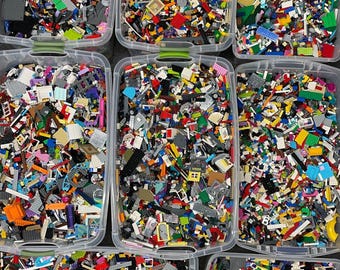 May include: Multiple containers filled with a variety of colorful Lego bricks. The bricks are sorted by color and type.