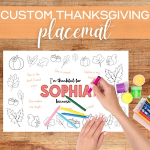 May include: A printable Thanksgiving placemat with a coloring page featuring a girl's name, Sophia, and a variety of fall-themed illustrations, including pumpkins, leaves, acorns, and squirrels. The text reads "I'm thankful for Sophia because..." and includes prompts for writing about Sophia's positive qualities.