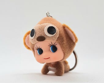 Mascota bebé con disfraz de elefante y muñeco cabezón Kewpie