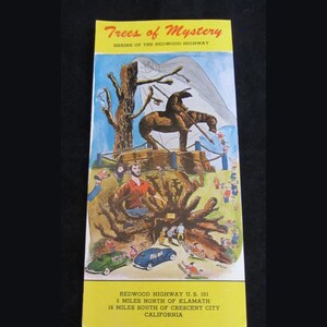 May include: A vintage postcard advertising Trees of Mystery, a roadside attraction on Redwood Highway U.S. 101 in California. The postcard features a cartoon illustration of a giant redwood tree with a whimsical scene of people and a horse.