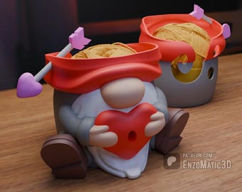 May include: A red and white gnome yarn bowl with a heart-shaped opening and an arrow through the top. The gnome is holding a red heart in its hands.