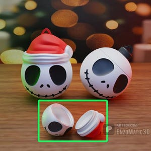 May include: White and black decorative ornaments with a smiling face design. One ornament is wearing a red Santa hat. The other ornament has a black top. The bottom of one ornament is shown separately.