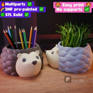 May include: Two hedgehog-shaped desk organizers. One holds colored pencils, the other has green plants. The organizers are gray and white with a textured, spiky design. The text on the image says "MultiParts", "3MF pre-painted", "STL Solid", "Easy print", and "No supports".