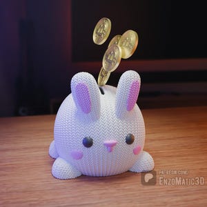 Pode incluir: Um cofrinho branco em forma de coelho com o interior das orelhas e bochechas rosa. Moedas de ouro estão caindo na fenda no topo. O cofrinho está em uma superfície de madeira. A imagem tem uma aparência suave, renderizada em 3D.