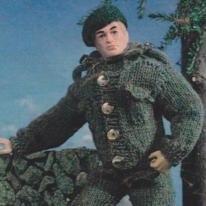 May include: A green knitted jacket with a hood and button closure. The jacket is worn by a doll with a green beret.
