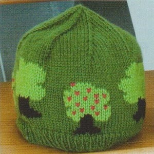 May include: A green knit hat with a tree design. The hat features a repeating pattern of green trees with red heart-shaped accents and dark brown trunks. The hat is made of a soft, textured yarn.