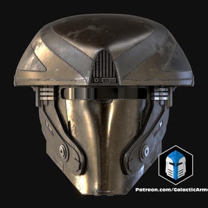 May include: A metallic, futuristic helmet with a dark, weathered finish. The helmet features a rounded top, a vented section above the face, and intricate details around the visor area. The design includes a logo that says "Galactic Armory".