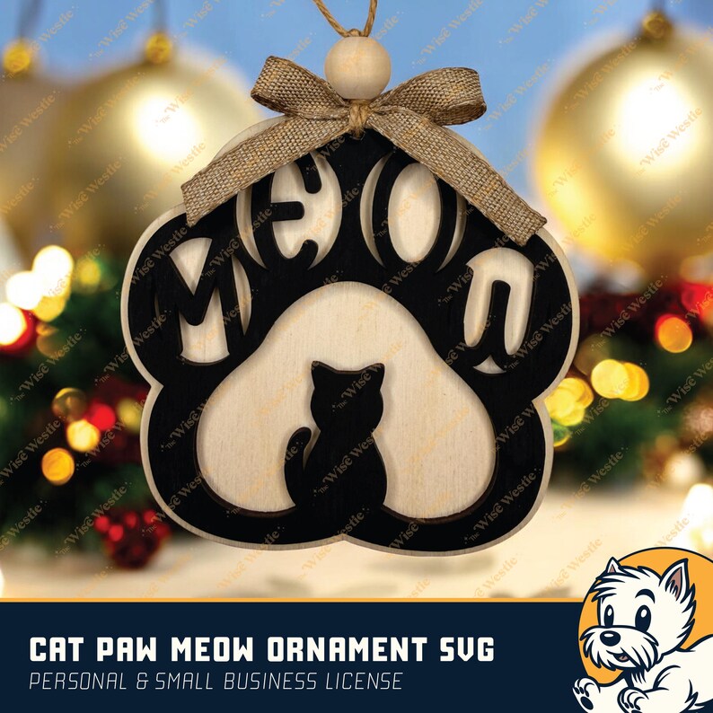 K&ouml;nnte beinhalten: Ein Holzornament in Form einer Katzenpfote mit dem ausgeschnittenen Wort "MEOW" und einer Katzen-Silhouette. Es hat eine Schleife aus Jute und eine Holzperle zum Aufh&auml;ngen. Der Text "CAT PAW MEOW ORNAMENT SVG" steht unten.
