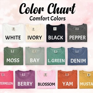 May include: A colour chart showing folded t-shirts in various colours, including white, ivory, black, pepper, moss, bay, L. green, denim, watermelon, berry, blossom, yam, and mustard. The text "Color Chart" and "Comfort Colors" are at the top.