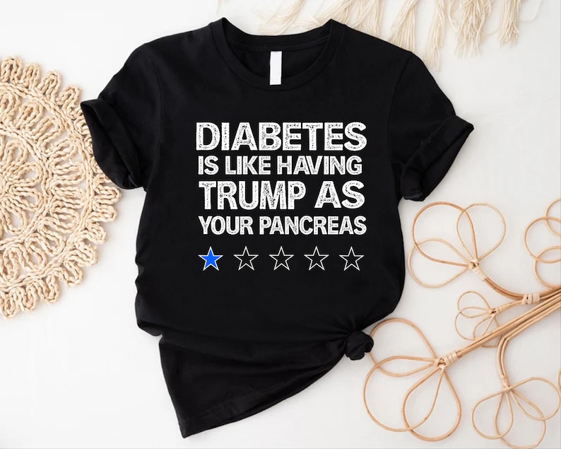 May include: A black t-shirt with the text 'Diabetes is like having Trump as your pancreas' in white text. Below the text are five white stars, the first star is blue.