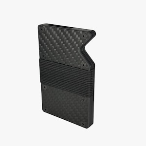 May include: A black carbon fiber wallet with a woven texture. The wallet has a black elastic band and is held together with black screws. The wallet has a unique angular design.
