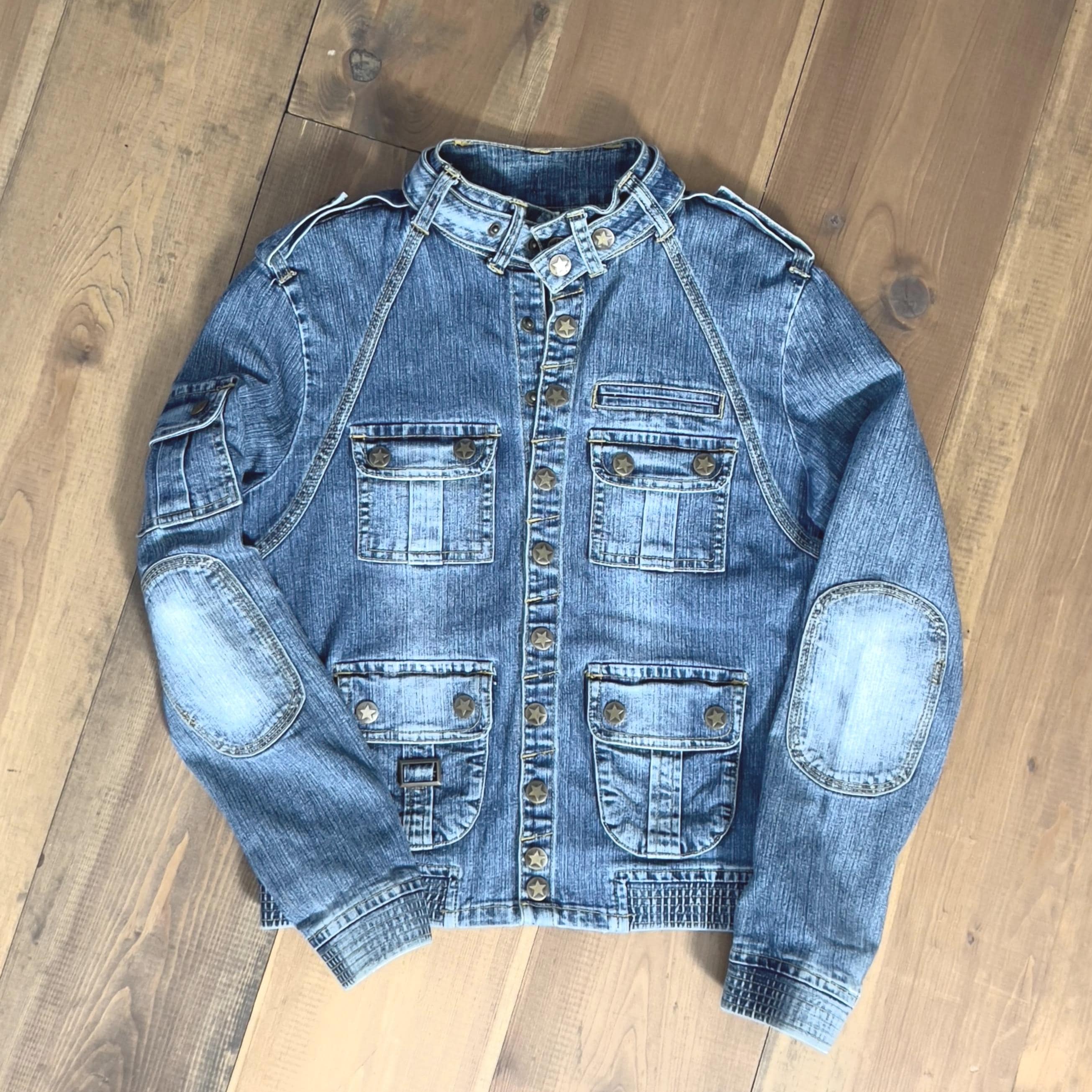 Distressed blue faded motorcycle-style denim jacket with multiple pockets and star-shaped snap buttons / Size S/M