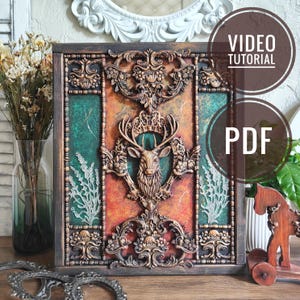 May include: A decorative framed artwork with a deer head centrepiece and elaborate floral and scrollwork. The colour scheme includes brown, gold, green, and orange tones, giving it an antique look. The image also includes the text "VIDEO TUTORIAL" and "PDF".