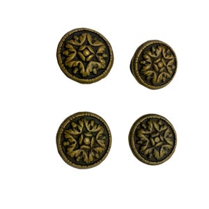 May include: Four antique gold-toned cabinet knobs with a floral design.