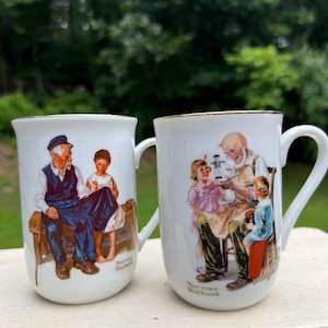 Vintage Norman Rockwell Mugs: &quot;Toymaker&quot; & &quot;Lighthouse Keeper&#39;s Daughter&quot; Set