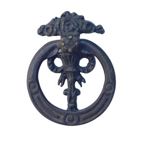 May include: A dark bronze cabinet pull with a circular ring and a decorative floral design in the center.