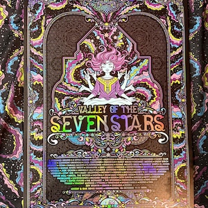May include: A rectangular poster titled Valley of the Seven Stars featuring a central figure with multiple arms in a meditative pose. The artwork includes vibrant pink, yellow, and blue swirling patterns, intricate borders, and a list of musical artists.