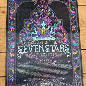 May include: A rectangular music festival poster titled Valley of the Seven Stars featuring a central figure with multiple arms in a meditative pose. The design includes vibrant pink, blue, and yellow cosmic patterns, intricate borders, and a list of artists.