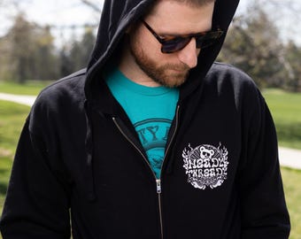 May include: Black zip-up hoodie with a white graphic of a bear wearing a crown and the text "Heady Threads" on the front.