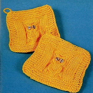 May include: Two yellow knitted pot holders with button eyes. The pot holders are square shaped and have a textured knit pattern.