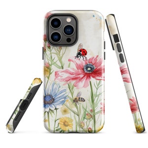 May include: A phone case with a watercolor design of flowers, a ladybug, and a bee. The case is white with a light brown background.